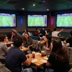 Betting excitement at a lively sports lounge showcasing keonhacai odds on large screens.